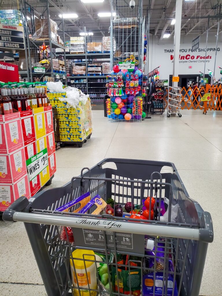 Shopping cart filled in a large grocery store.