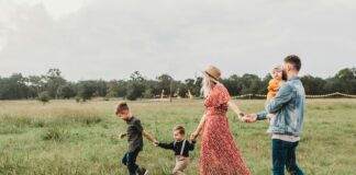 woman holding man and toddler hands during daytime