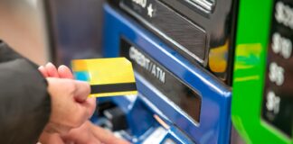 a person using a credit card to pay for a machine