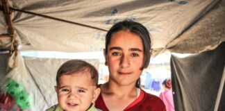 a woman holding a baby in her arms