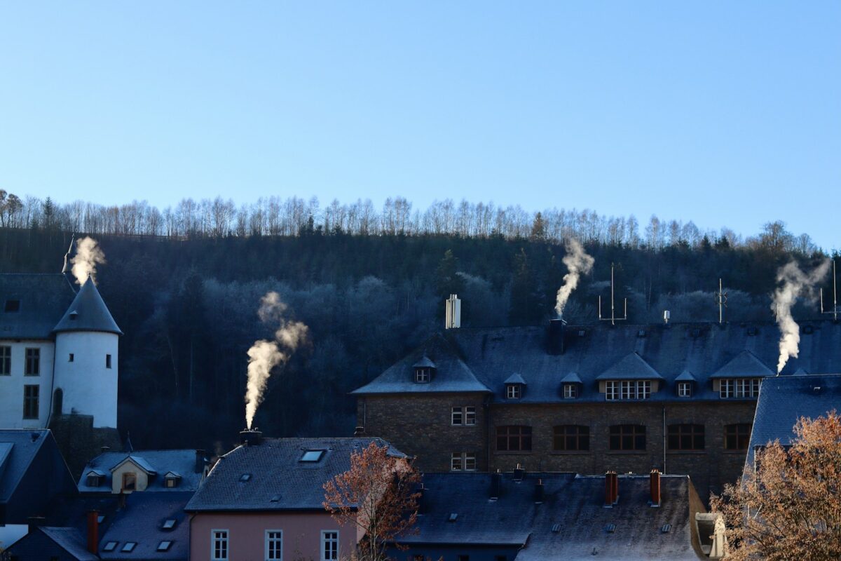 smoke coming out of the chimneys of a building