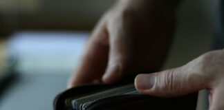 a person holding a wallet in their hand