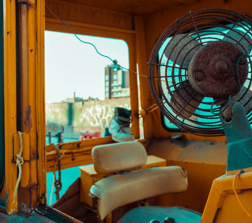 white and blue box fan on yellow leather chair
