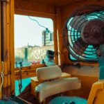 white and blue box fan on yellow leather chair