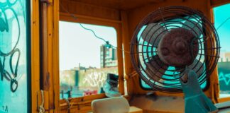 white and blue box fan on yellow leather chair