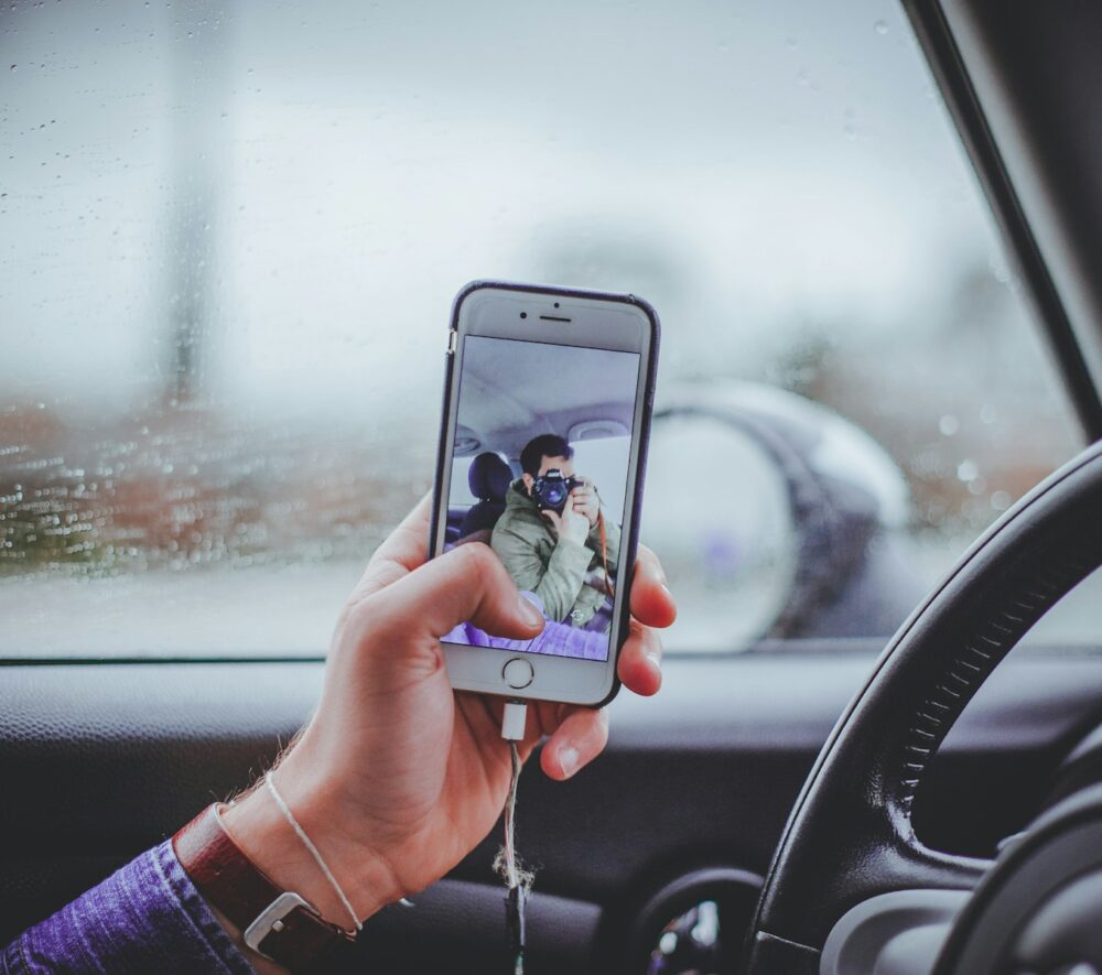 person taking selfie inside the car