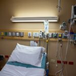 An empty hospital bed awaits a patient.