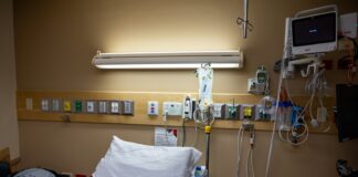 An empty hospital bed awaits a patient.