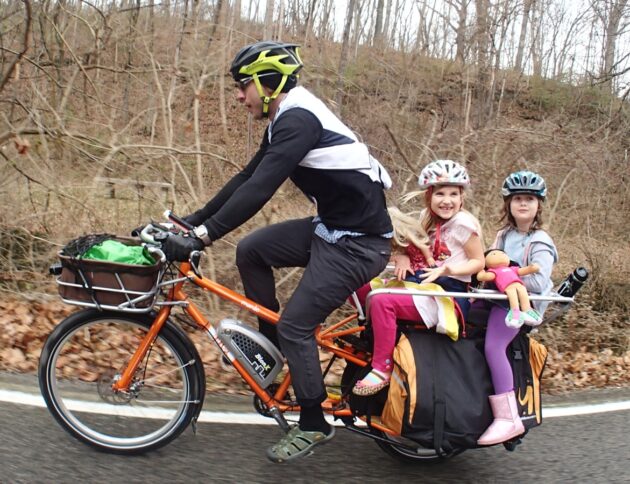 people riding on orange bicycles during daytime/ fot: Mark Stosberg/ Unsplash