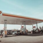 vehicles and people on Shell gasoline station during daytime