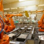 a factory filled with lots of orange machines