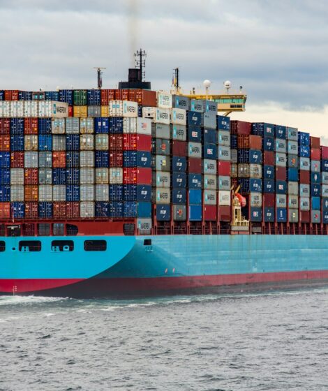 blue and red cargo ship on sea during daytime